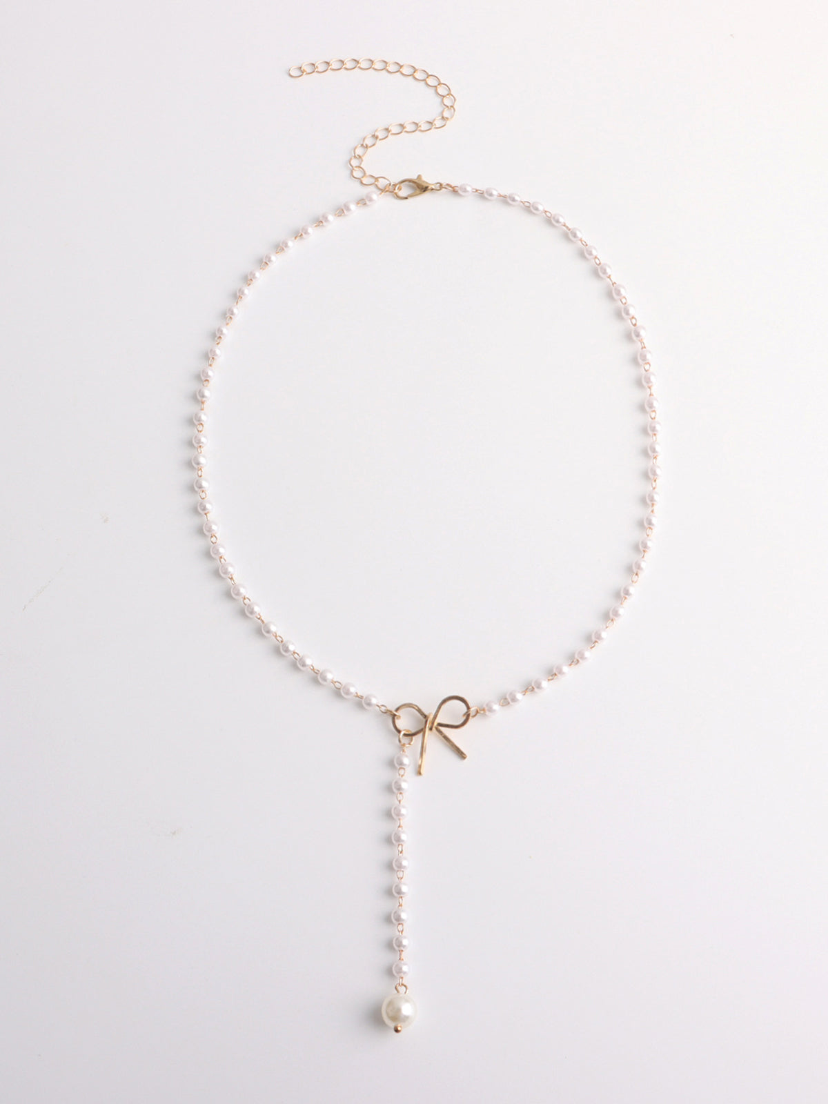 Halsband med pärlhänge och rosett