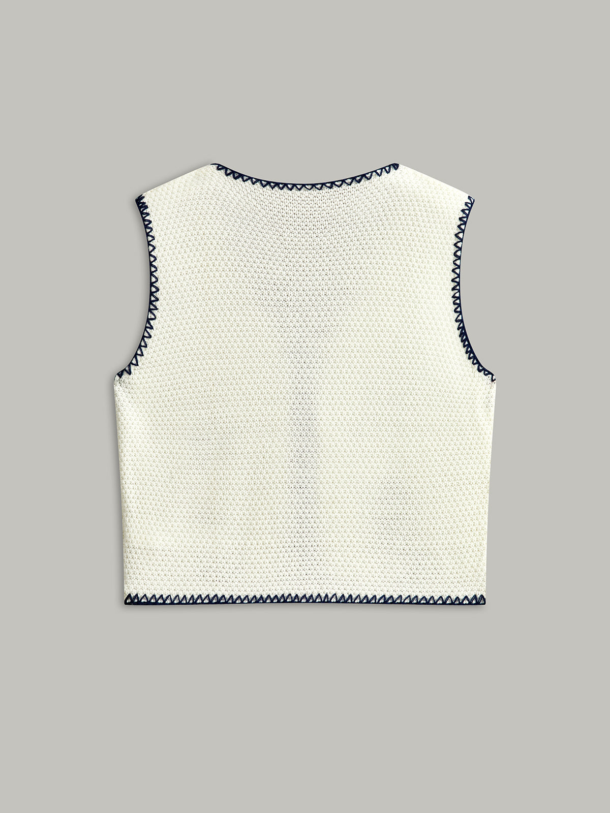 Broderad stickad väst med knytband framtill 